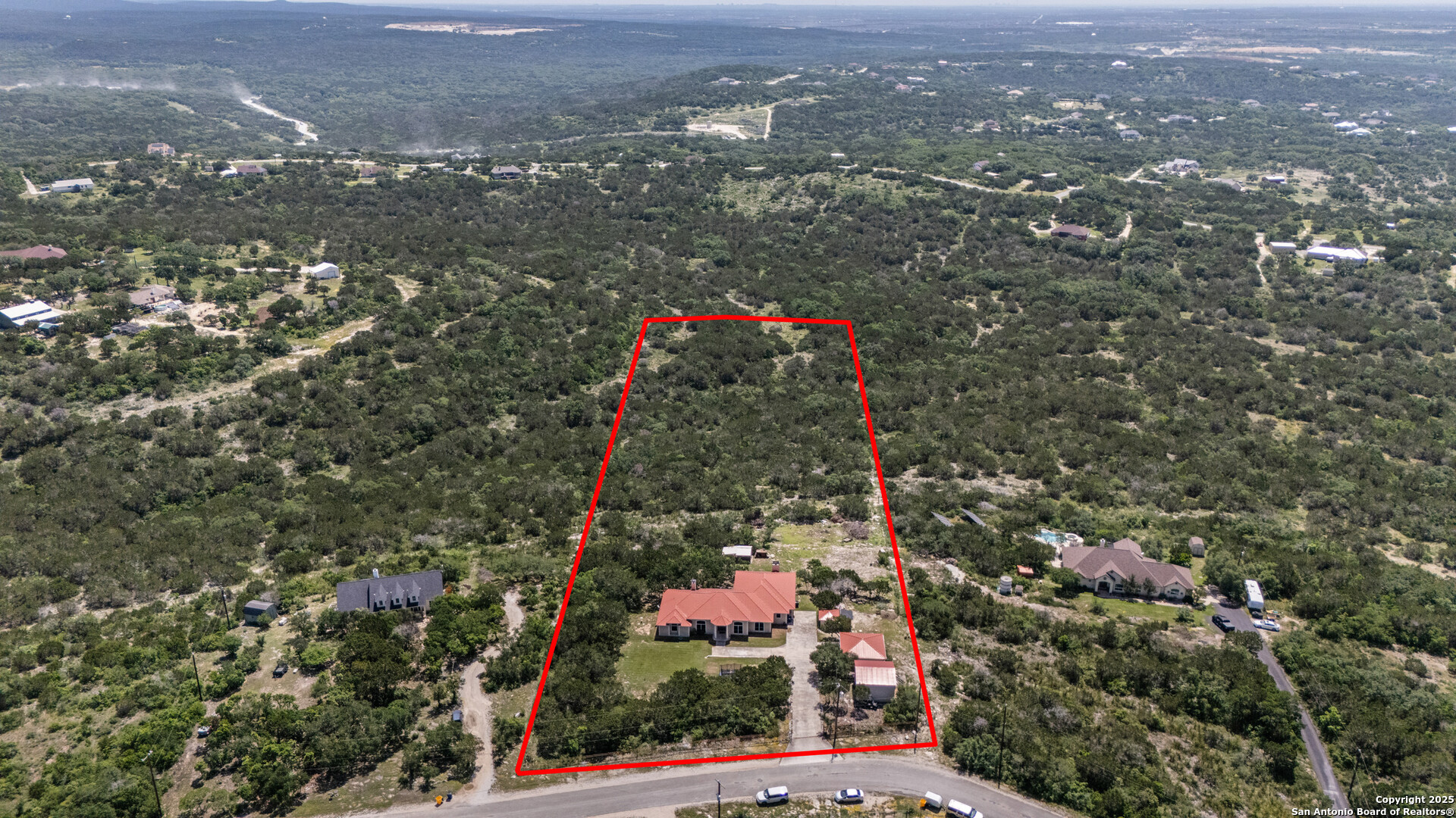 165 County Road 2740 Mico, TX 78056 - Photo 26 of 30 an aerial view of residential houses with city and green space