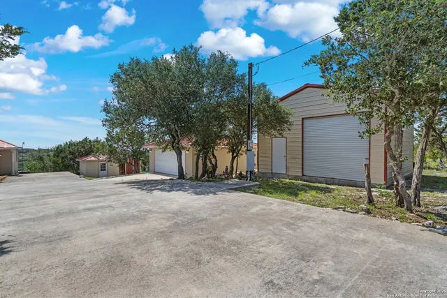 a view of a house with a tree and plants