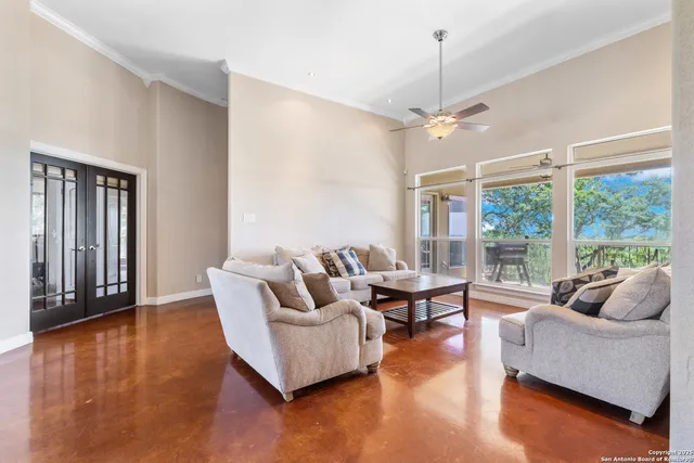 a living room with furniture and large windows