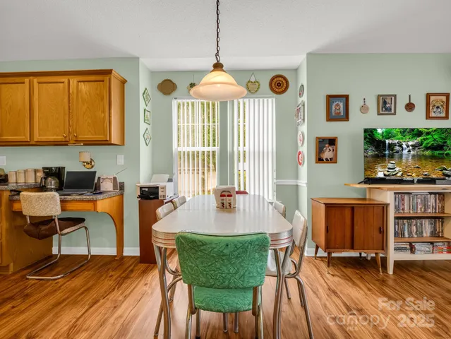 a living room with furniture a window and a chandelier
