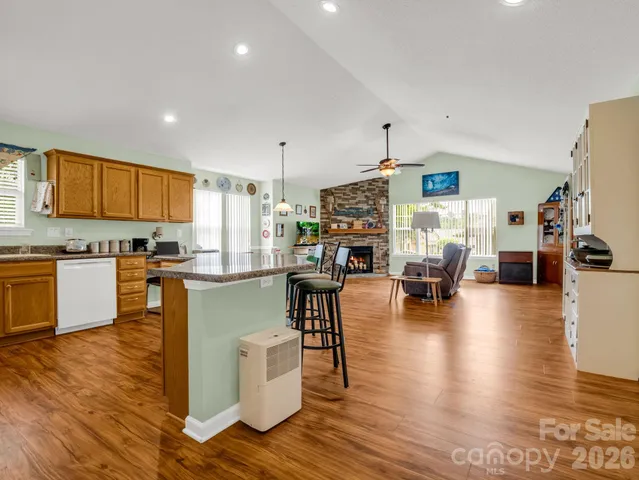 a kitchen with dining table stainless steel appliances and wooden floor