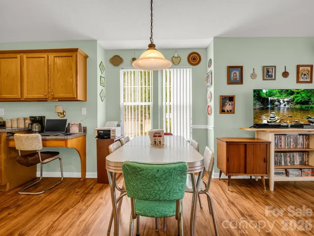 a living room with furniture a window and a chandelier