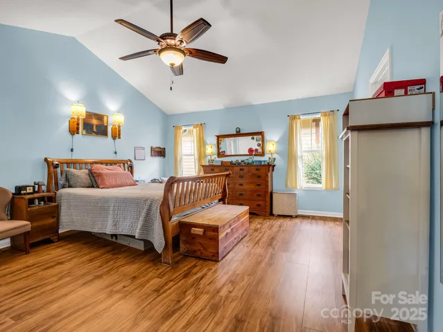 a bedroom with furniture and a wooden floor