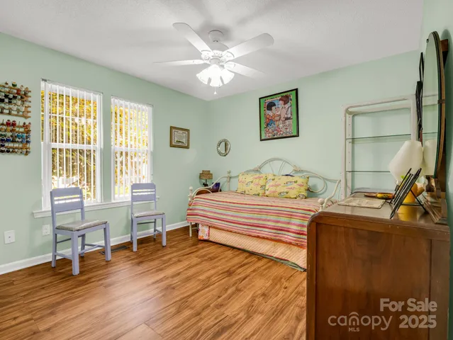 a spacious bedroom with a bed and a table in it