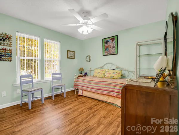 a spacious bedroom with a bed and a table in it
