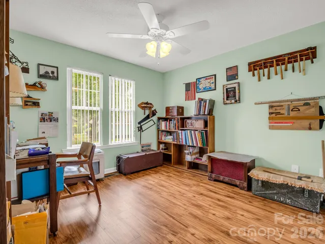 a living room with furniture and book shelf