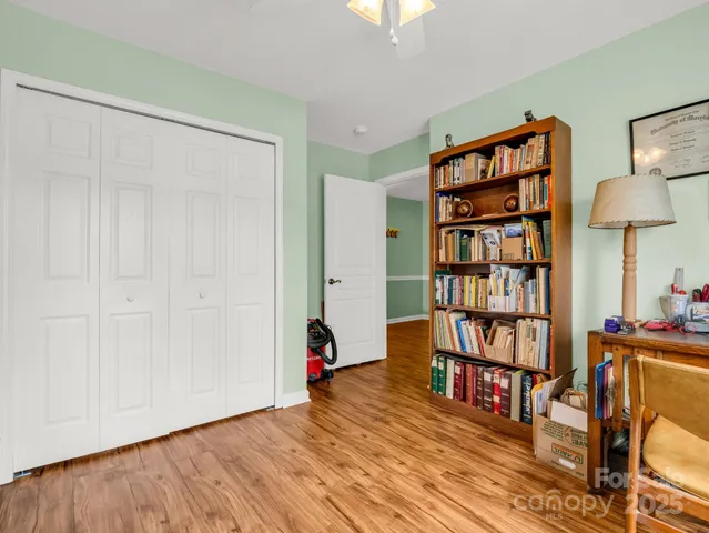 a view of a workspace with furniture and wooden floor