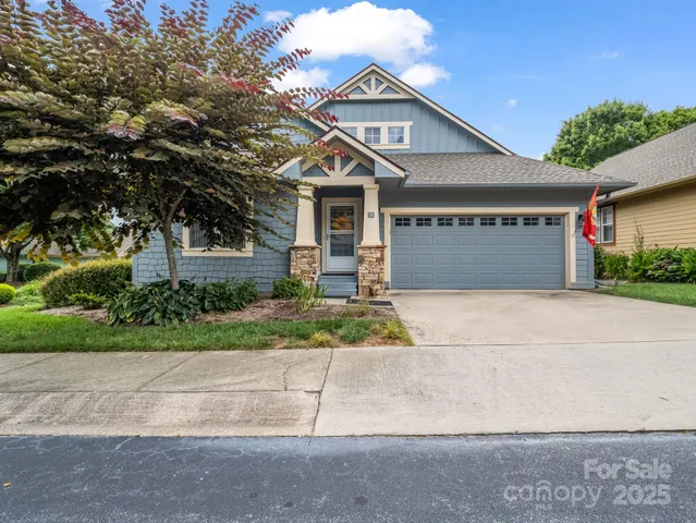 a front view of a house with a yard and a garage