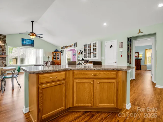 a kitchen with stainless steel appliances granite countertop a refrigerator and a stove top oven