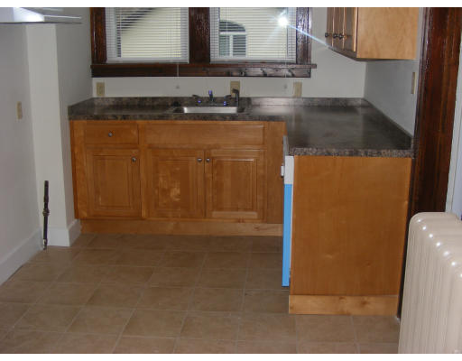 59 Ionia Street Springfield, MA 01109 - Photo 3 of 6 a bathroom with a granite countertop sink and a mirror