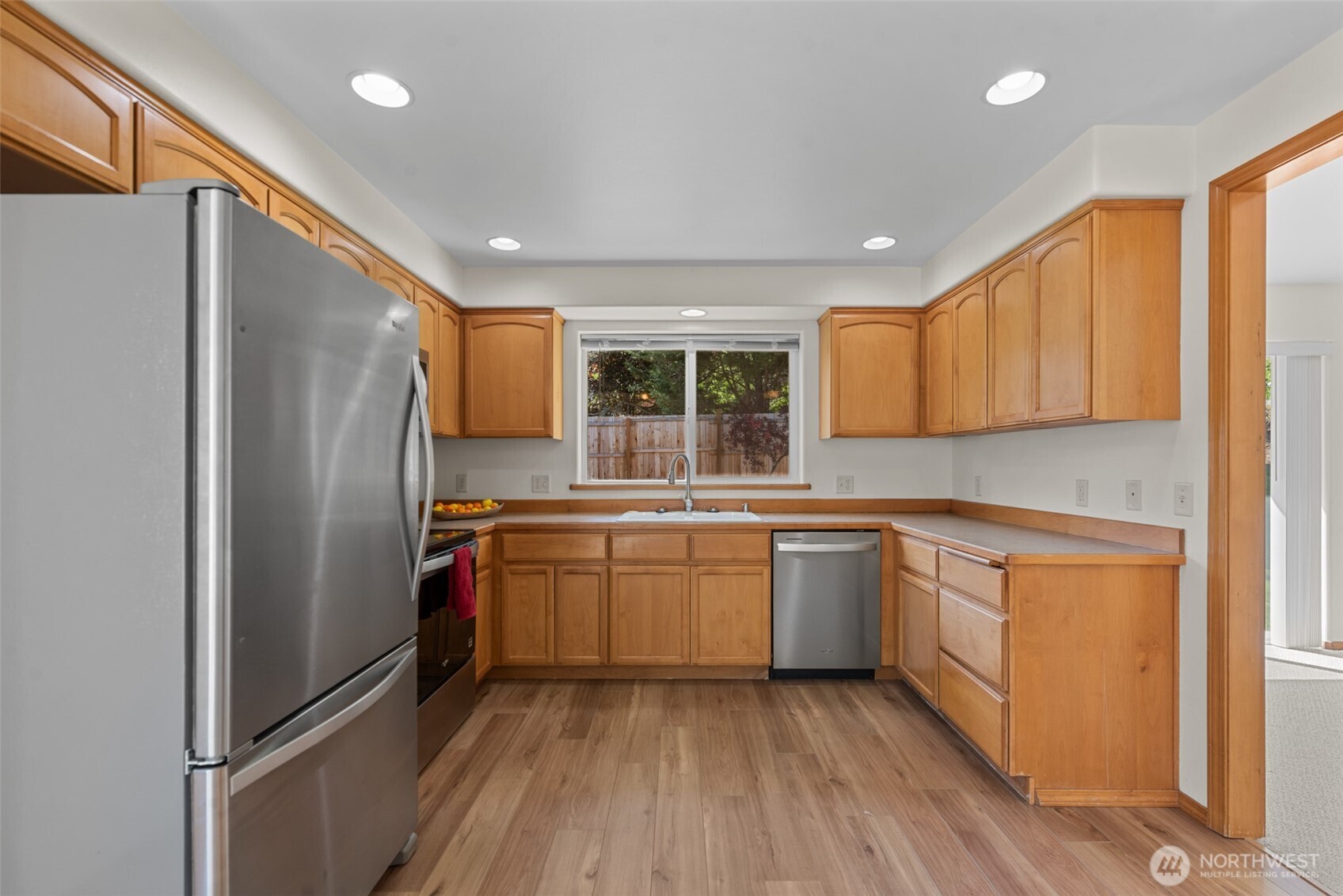 1111 Splett Street Wenatchee, WA 98801 - Photo 15 of 36 a kitchen with stainless steel appliances granite countertop a refrigerator a sink dishwasher a stove and white countertops with wooden floor