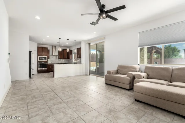 a living room with furniture and kitchen view