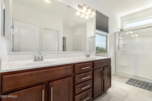 a bathroom with a sink double vanity and a mirror
