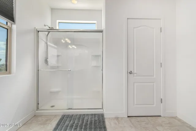 a bathroom with a glass shower door
