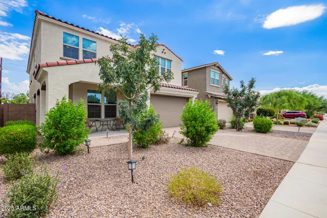 a front view of a house with garden