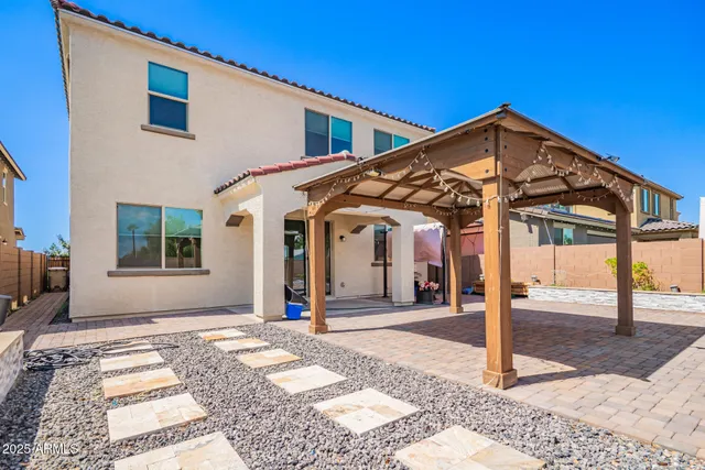 a front view of a building with large trees