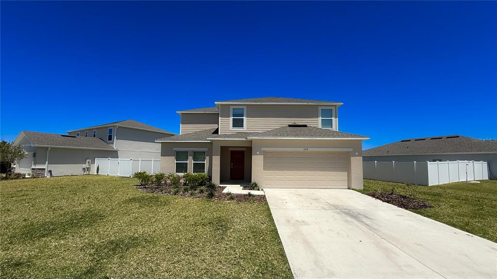 a front view of a house with a yard