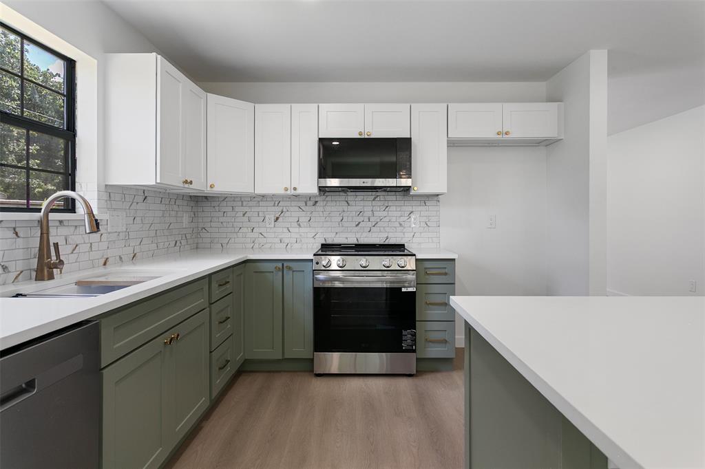 1346 South Reno Road Springtown, TX 76082 - Photo 5 of 24 Modern kitchen featuring two-tone cabinetry, white countertops, and a subway tile backsplash