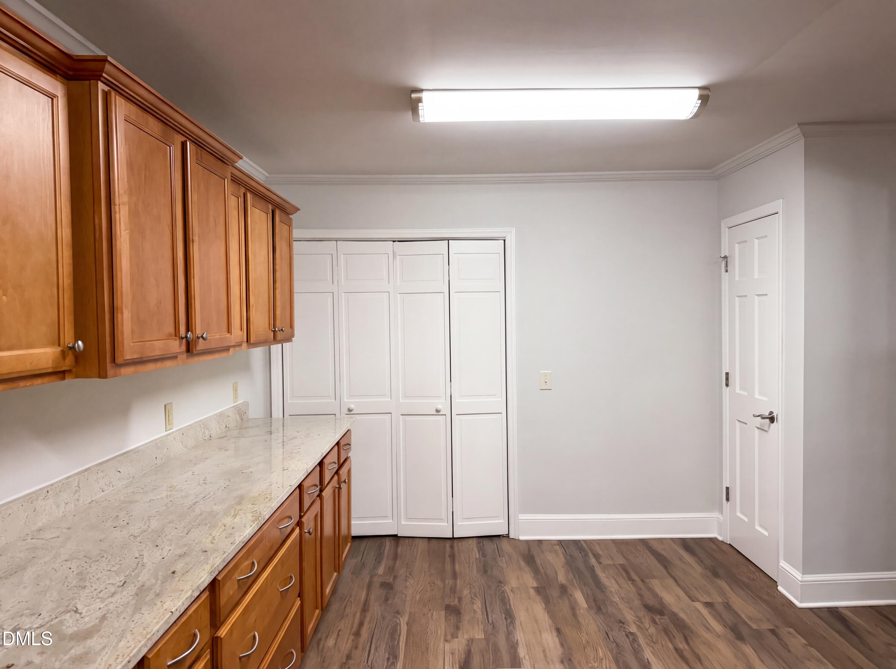 102 Lakeside Farm Road Zebulon, NC 27597 - Photo 9 of 18 a view of hallway with wooden floor and cabinet