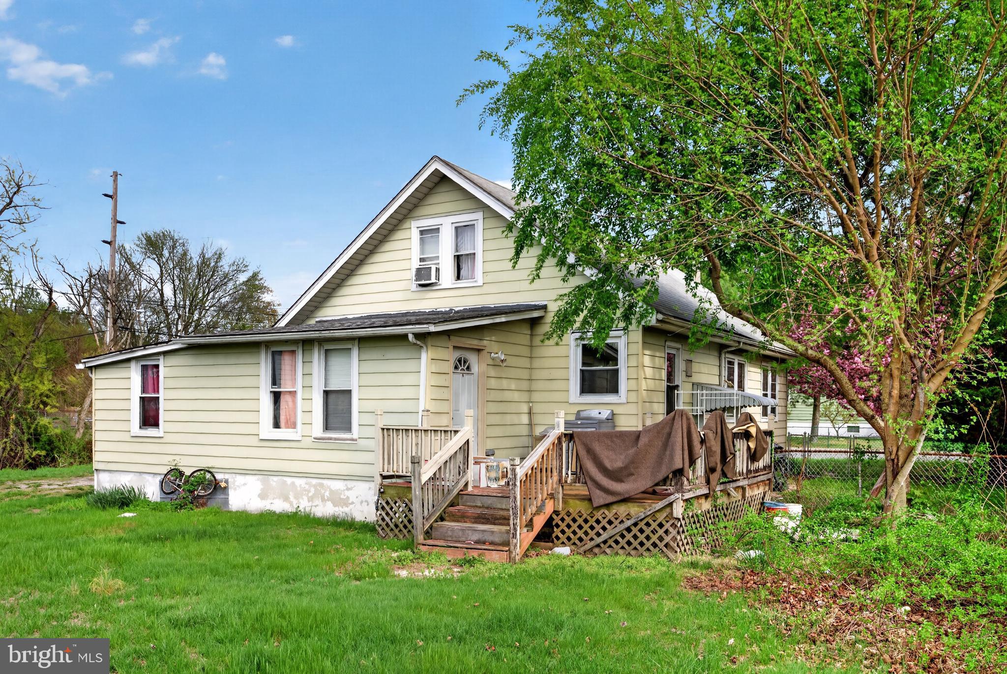 242 Broad Street Carneys Point, NJ 08069 - Photo 6 of 6 a front view of a house with a garden