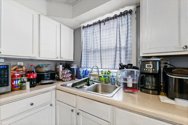a kitchen with appliances a sink and cabinets