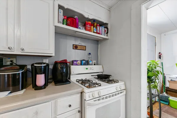 a kitchen with a stove and cabinets