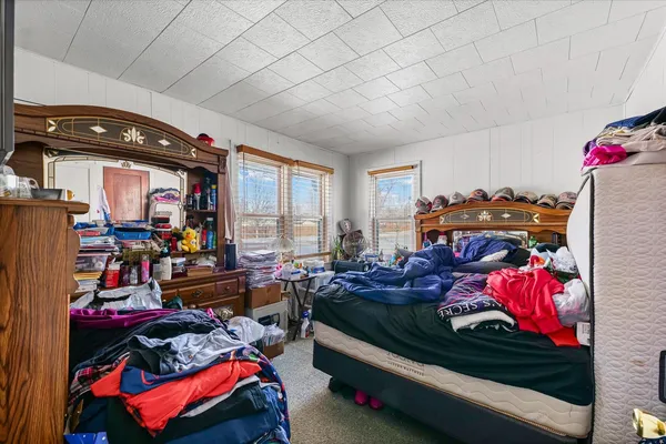 a bedroom with furniture and a flat screen tv