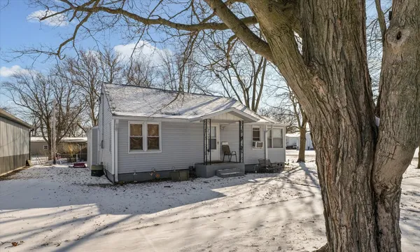 a view of a house with a yard covered in snow