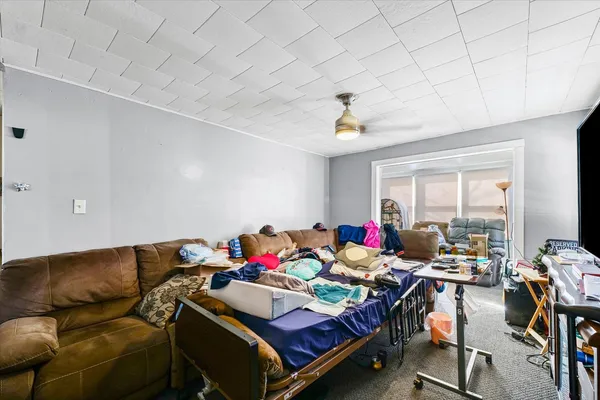 a bedroom with furniture and a large window
