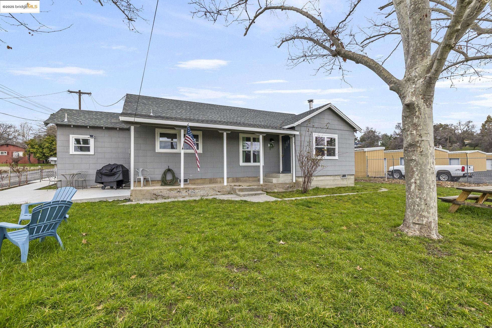 a front view of house with yard and seating area