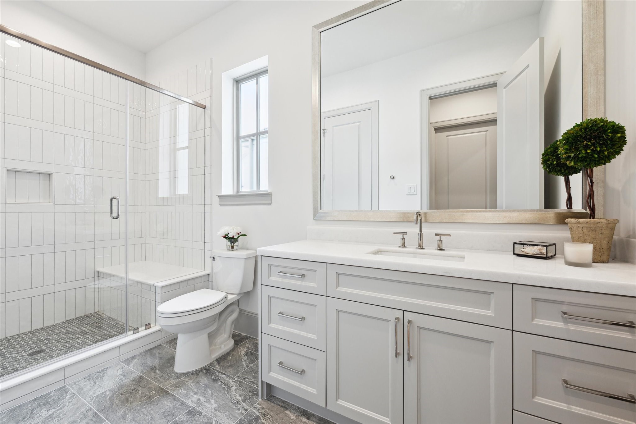 207 Sutton Row Place Houston, TX 77024 - Photo 19 of 29 Full bath off secondary features glass enclosed shower with seat and Opal White Polished Marble countertops.