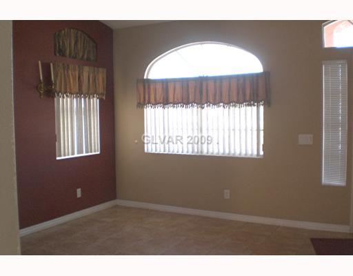 929 Longshanks Road Henderson, NV 89015 - Photo 6 of 7 Living Room. LIVING RM W/ CUSTOM DESIGN AND TILE FLOORING