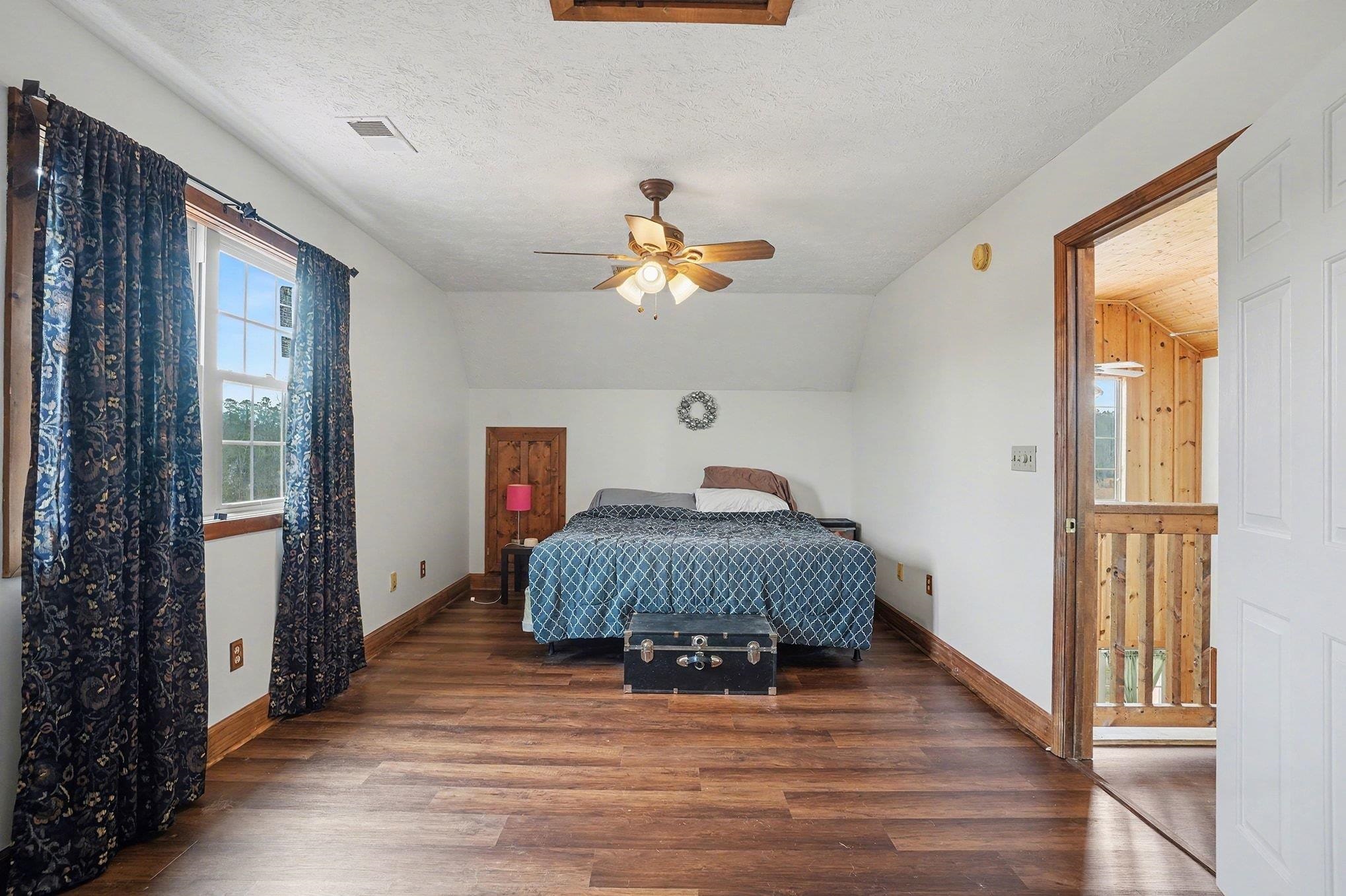 202 Highway 747 Loris Sc 29569 Loris, SC 29569 - Photo 18 of 34 Bedroom with wood finished floors, a textured ceiling, a ceiling fan, and vaulted ceiling