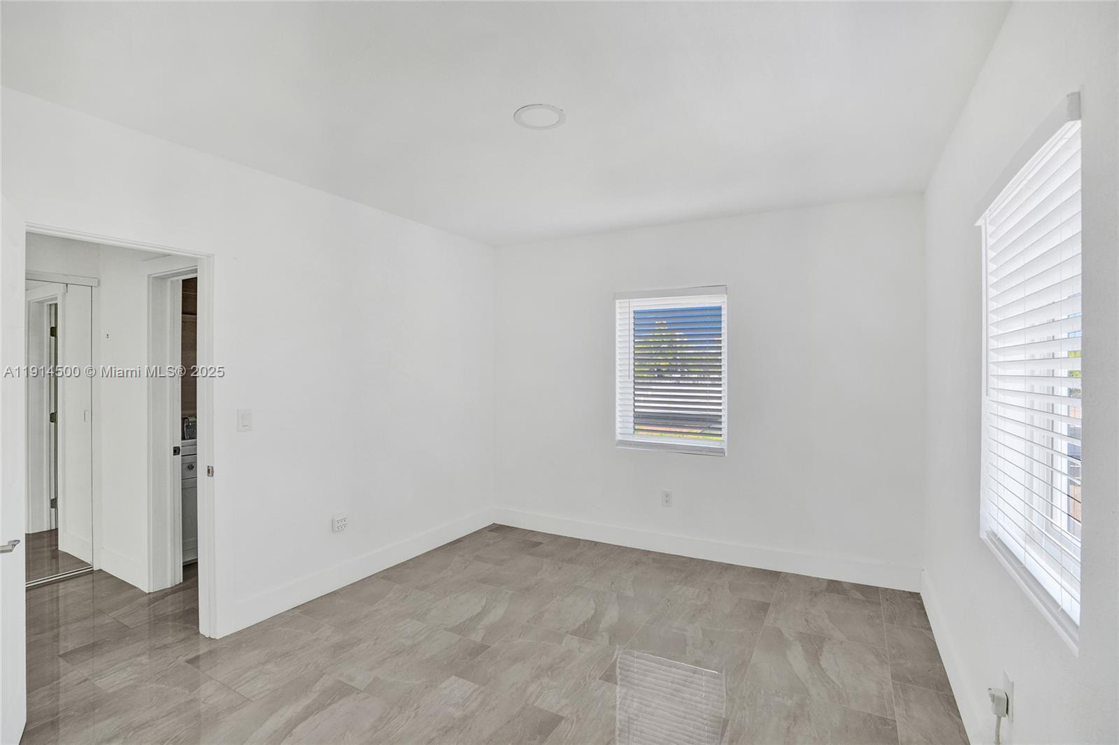 7115 Rue Granville, Unit C Miami Beach, FL 33141 - Photo 11 of 25 an empty room with windows
