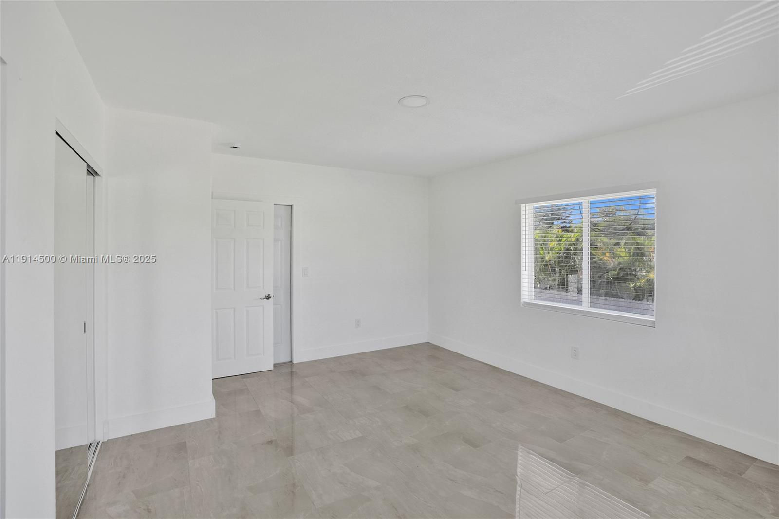 7115 Rue Granville, Unit C Miami Beach, FL 33141 - Photo 12 of 25 a view of an empty room with a window