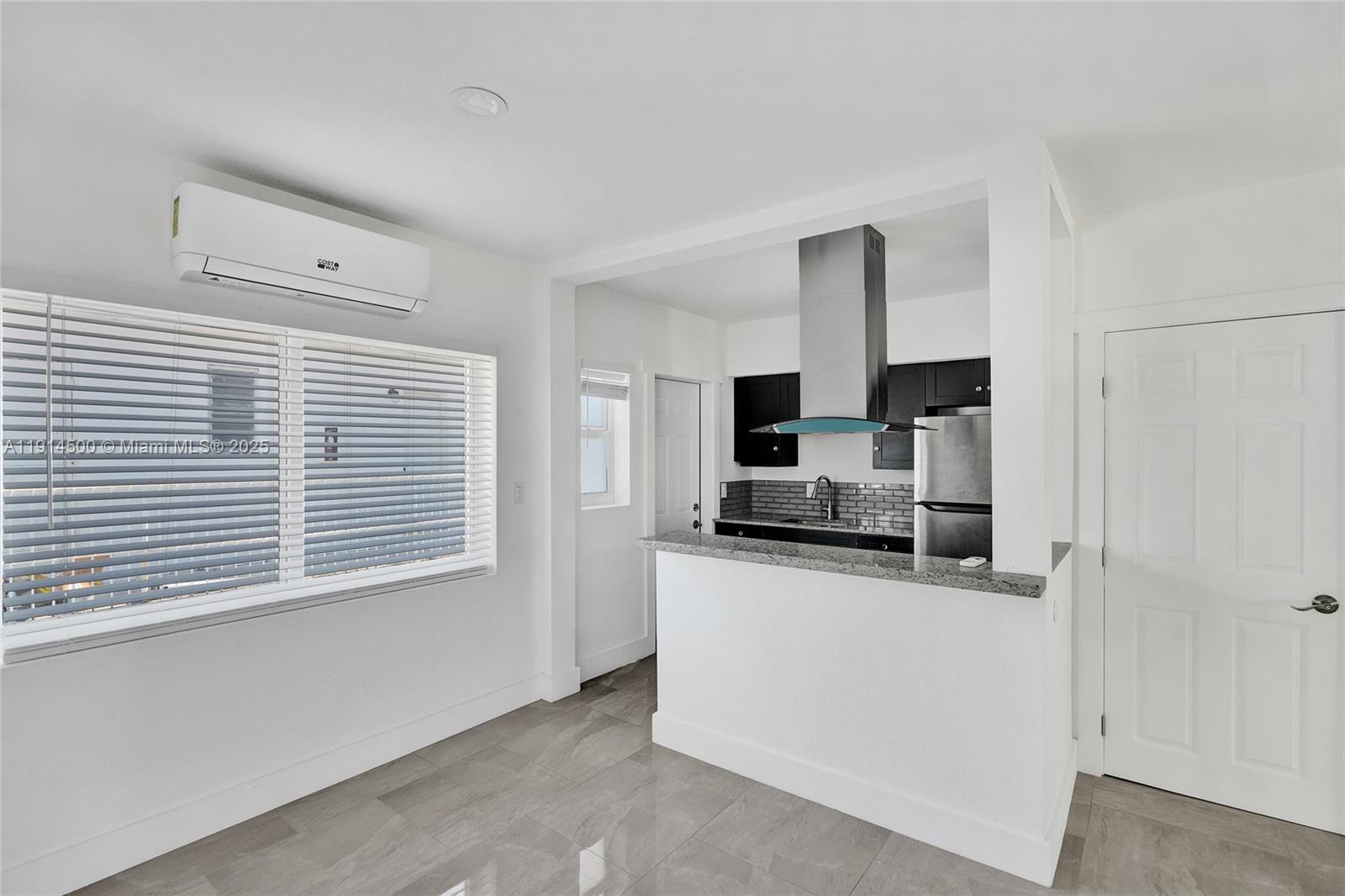 7115 Rue Granville, Unit C Miami Beach, FL 33141 - Photo 13 of 25 a kitchen with stainless steel appliances a sink and a stove