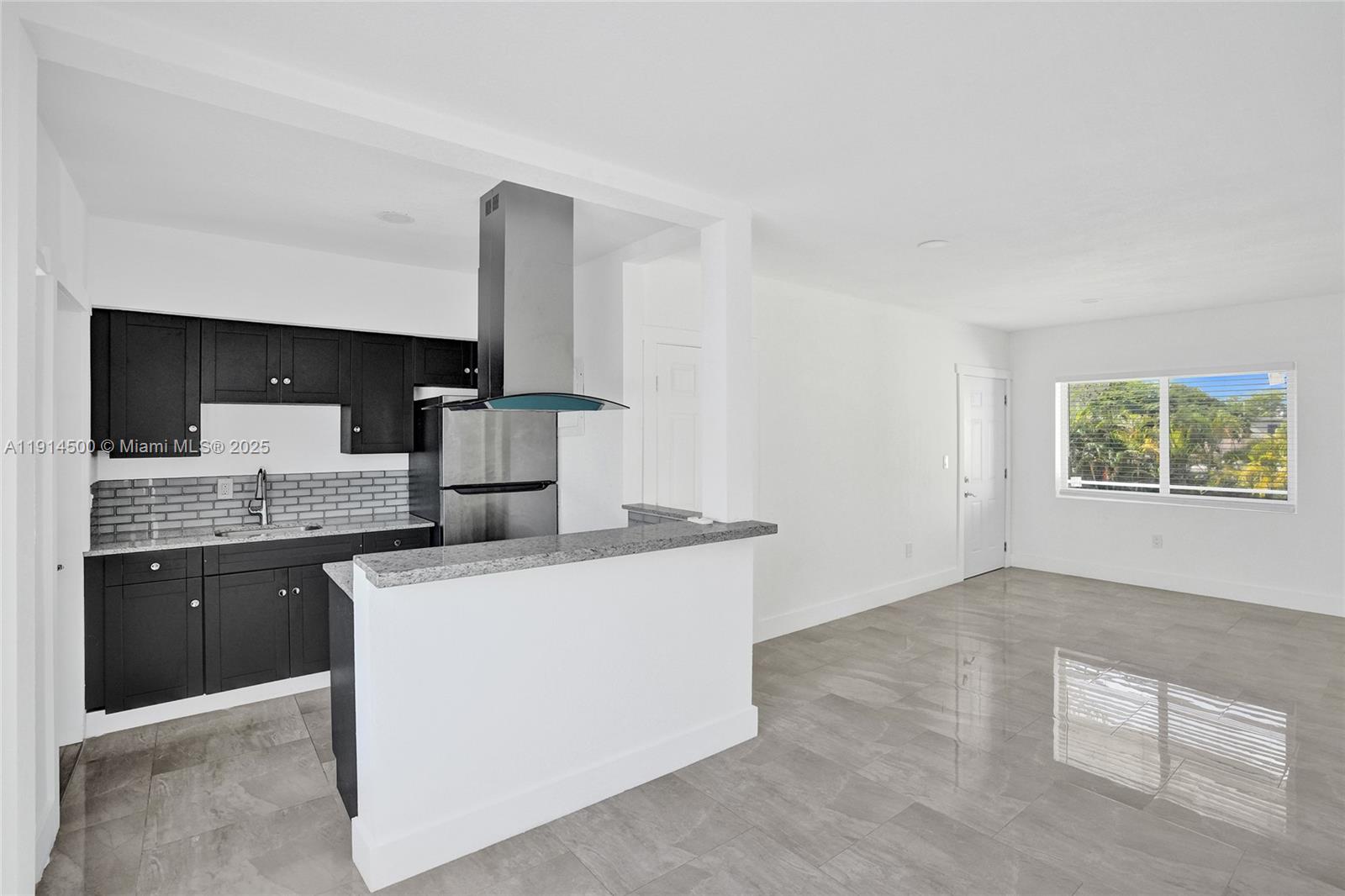 7115 Rue Granville, Unit C Miami Beach, FL 33141 - Photo 16 of 25 a kitchen with a stove and a sink