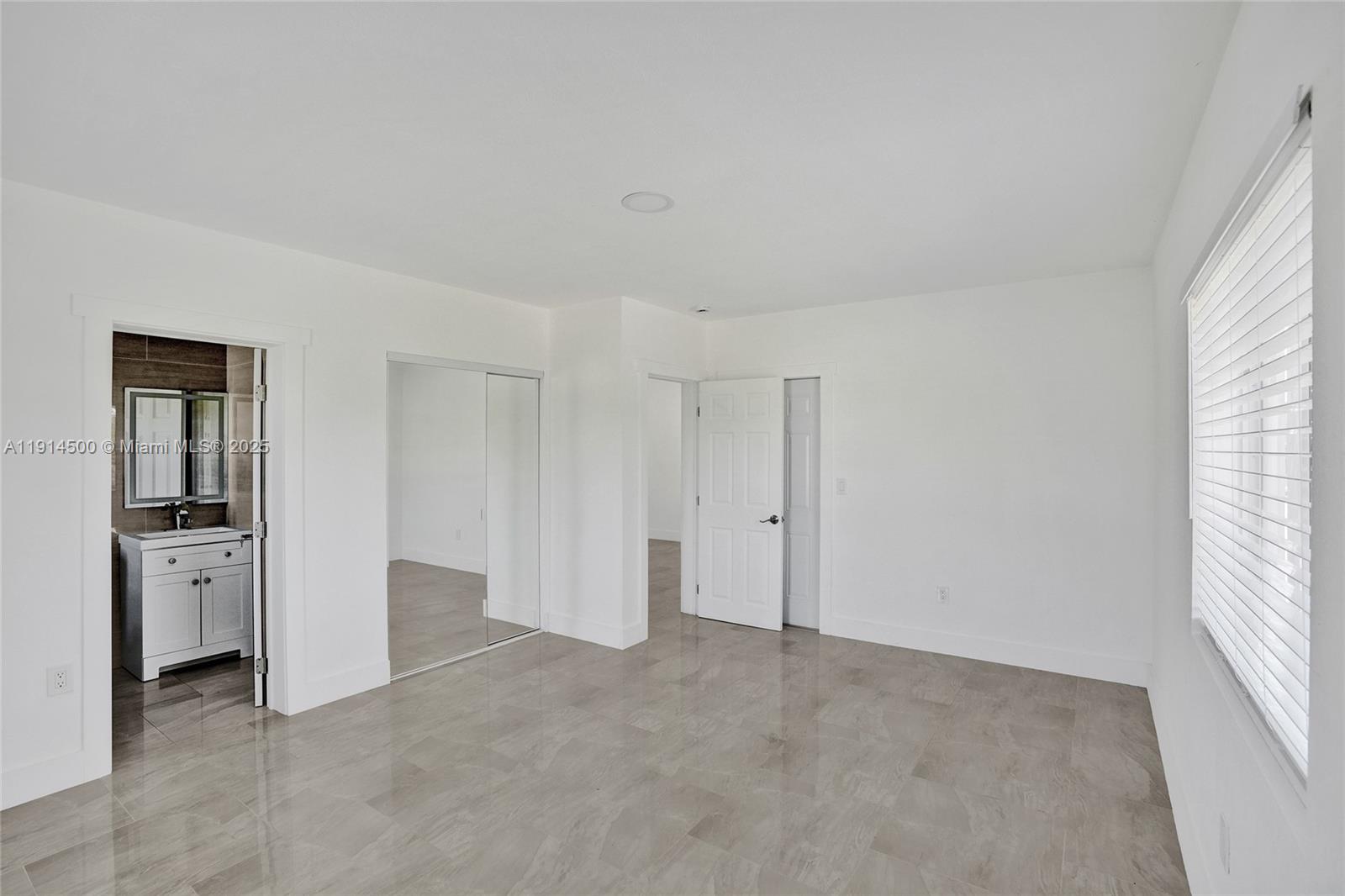 7115 Rue Granville, Unit C Miami Beach, FL 33141 - Photo 18 of 25 a view of an empty room with a window