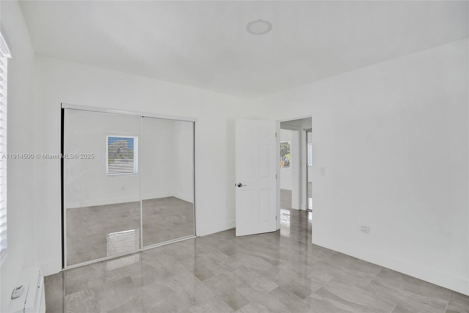 7115 Rue Granville, Unit C Miami Beach, FL 33141 - Photo 20 of 25 an empty room with closet area