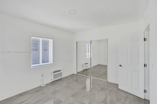 a view of an empty room with a window