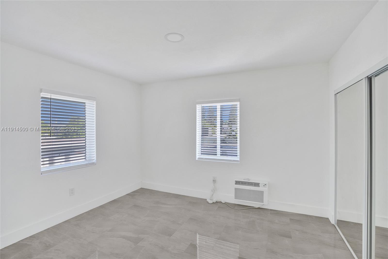 7115 Rue Granville, Unit C Miami Beach, FL 33141 - Photo 22 of 25 an empty room with windows