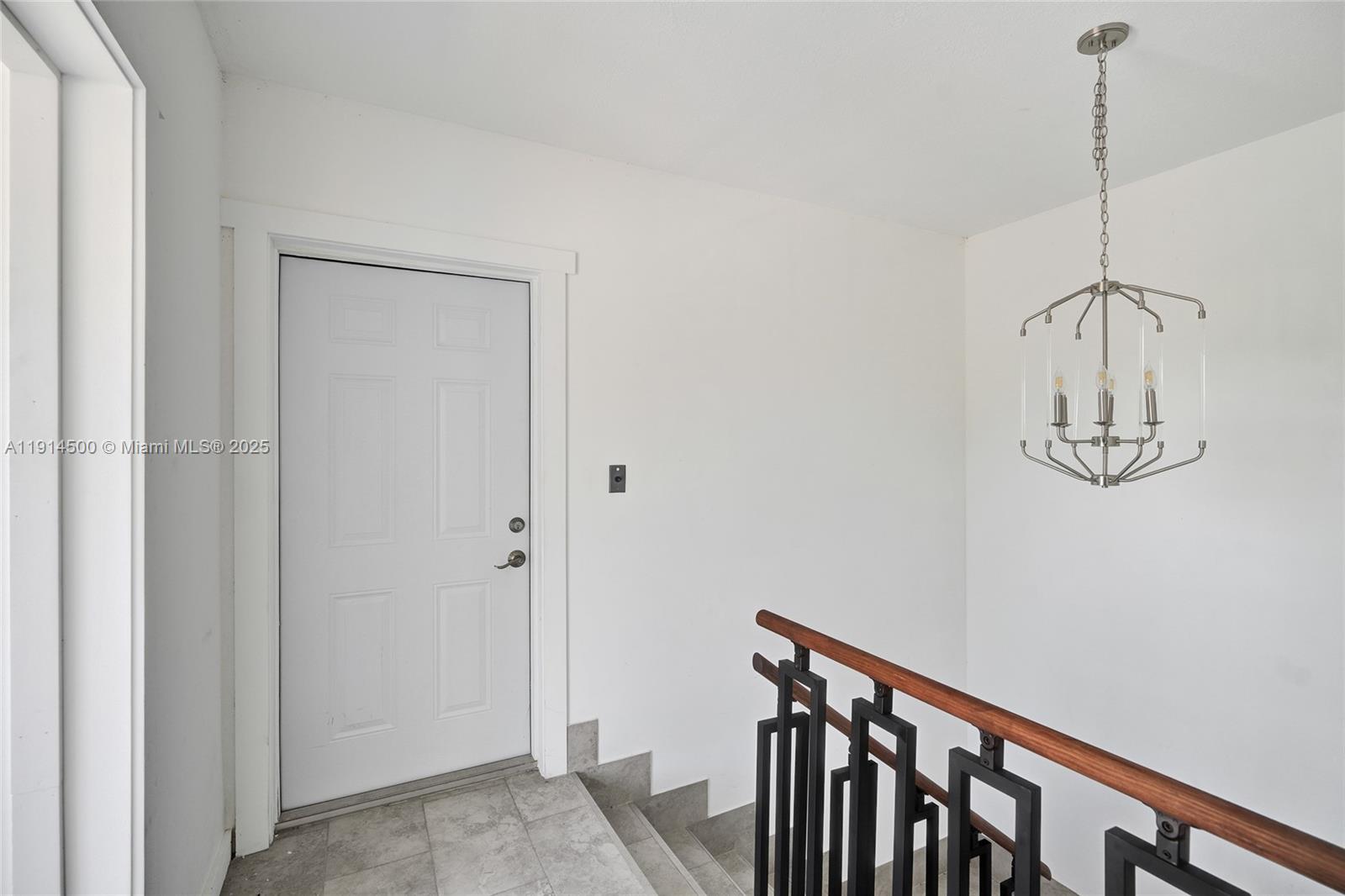 7115 Rue Granville, Unit C Miami Beach, FL 33141 - Photo 7 of 25 a view of a hallway with a chandelier