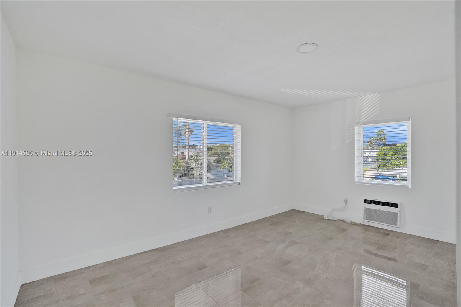 7115 Rue Granville, Unit C Miami Beach, FL 33141 - Photo 10 of 25 a view of an empty room with a window