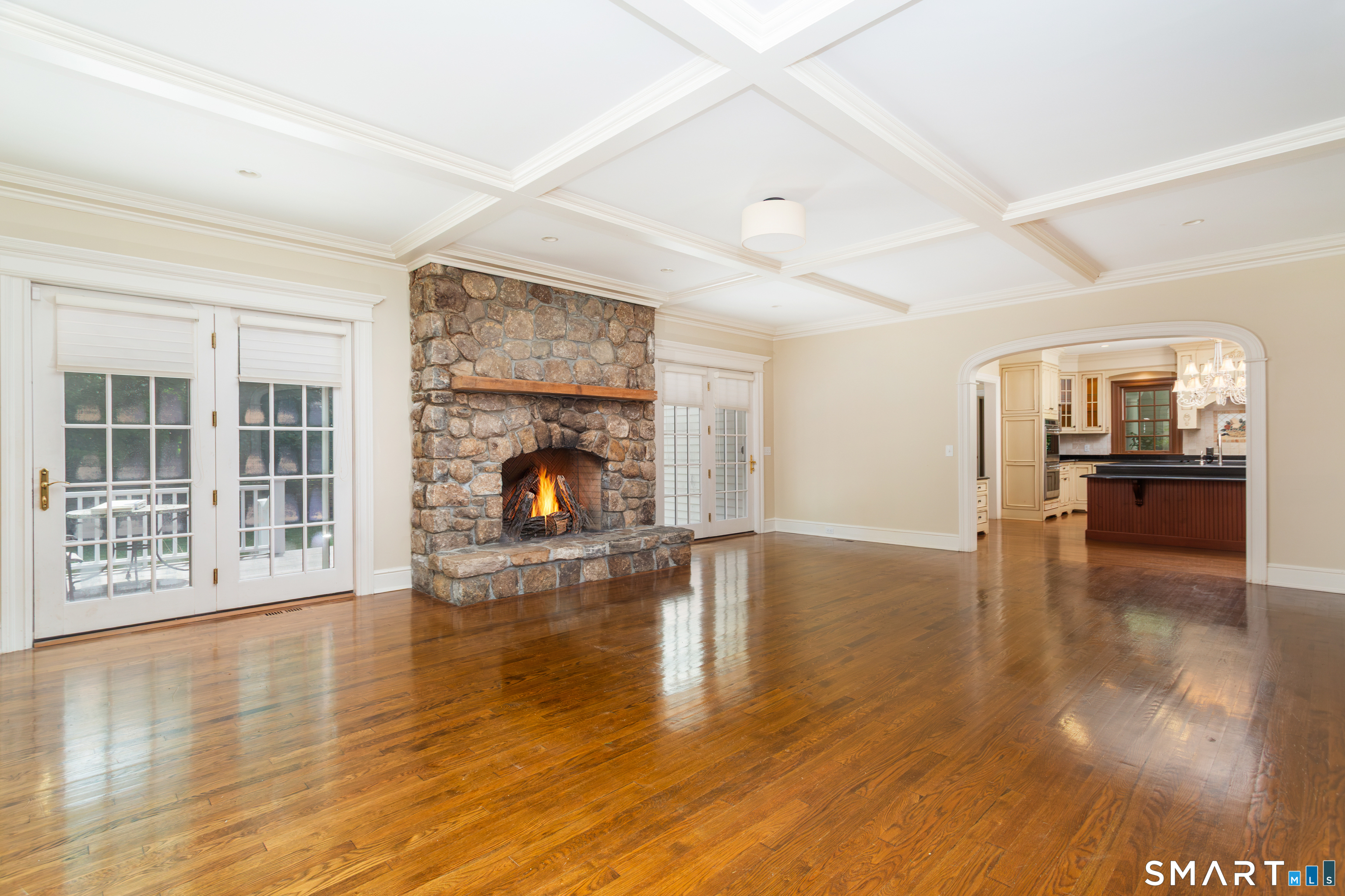 7 Old Hyde Road Weston, CT 06883 - Photo 15 of 40 Family room with stone fireplace and French doors to deck