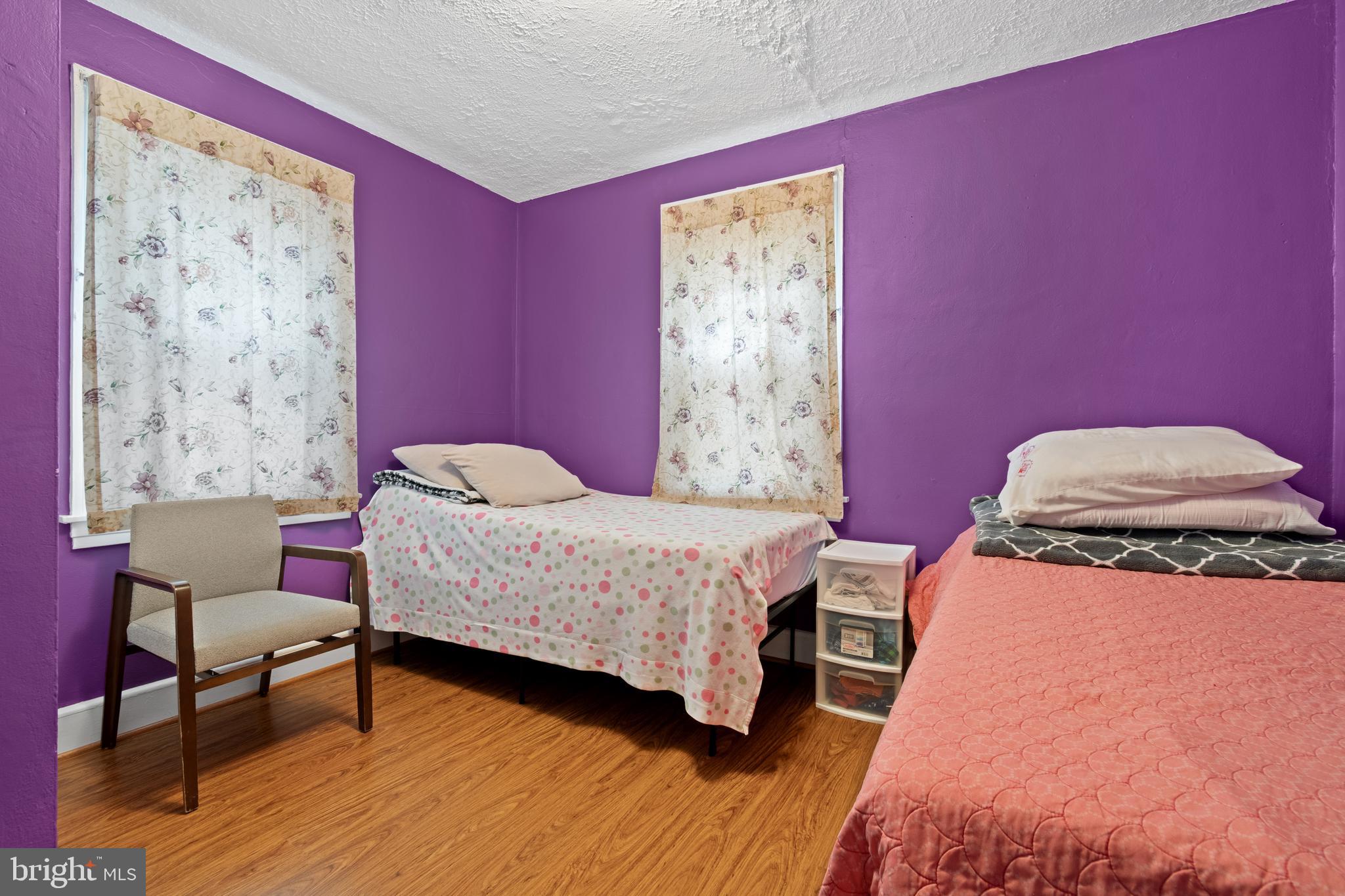 4410 Allies Road Suitland, MD 20746 - Photo 14 of 30 a bedroom with a bed and a chair