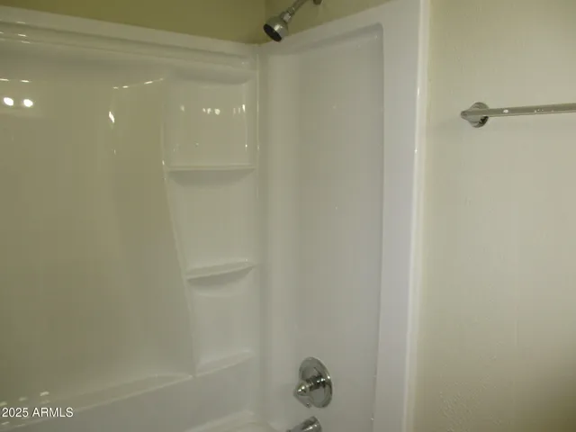 a bathroom with a sink and mirror with toilet