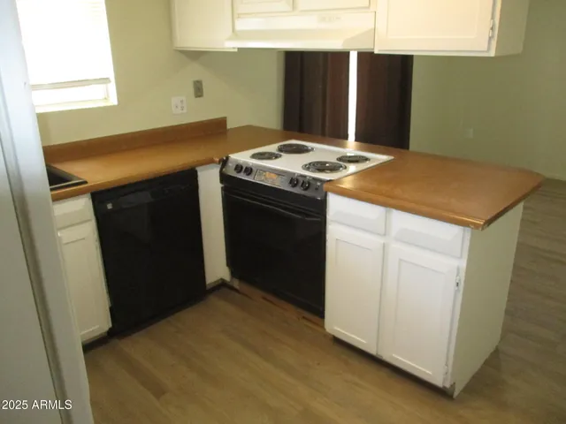 a kitchen with a sink a stove and a refrigerator