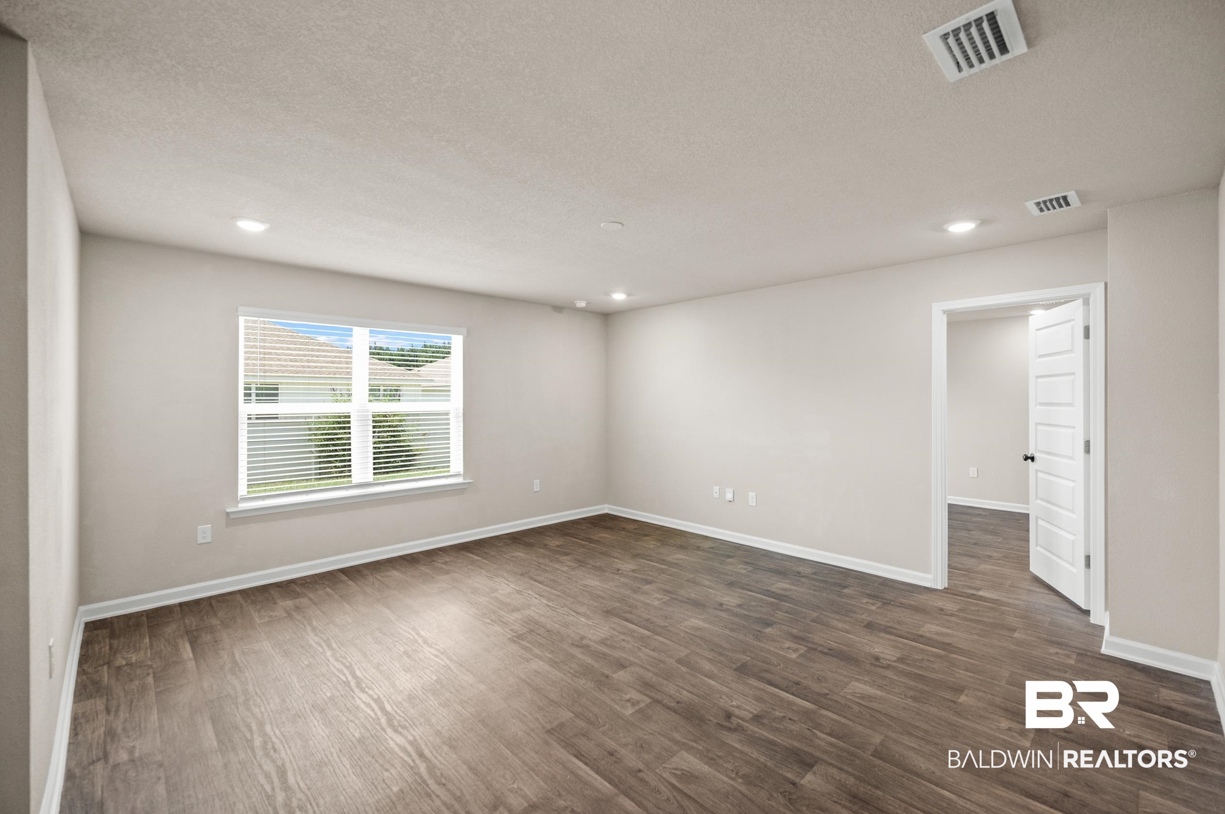 10353 Zenyatta Loop Daphne, AL 36526 - Photo 10 of 33 Unfurnished bedroom with a textured ceiling and wood-type flooring