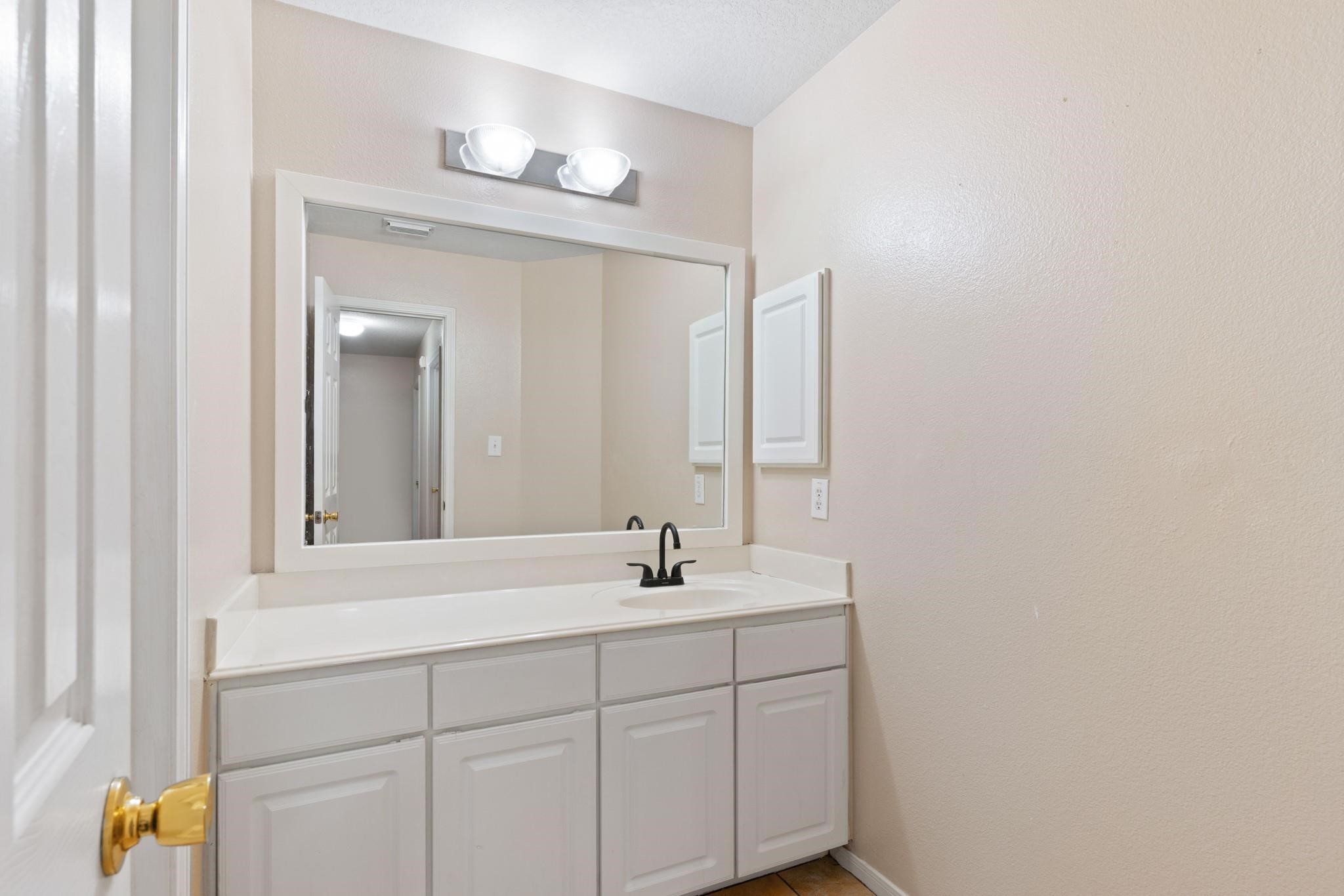 5038 Forest Hurst Drive Spring, TX 77373 - Photo 11 of 22 a bathroom with a sink and a mirror