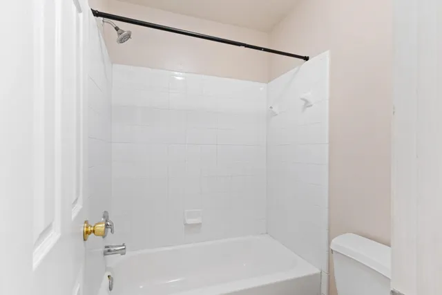 a bathroom with a shower and a bath tub